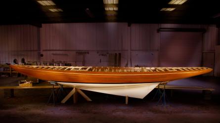 International Class Dragon Sailing Yacht, on the hard inside a building with lights